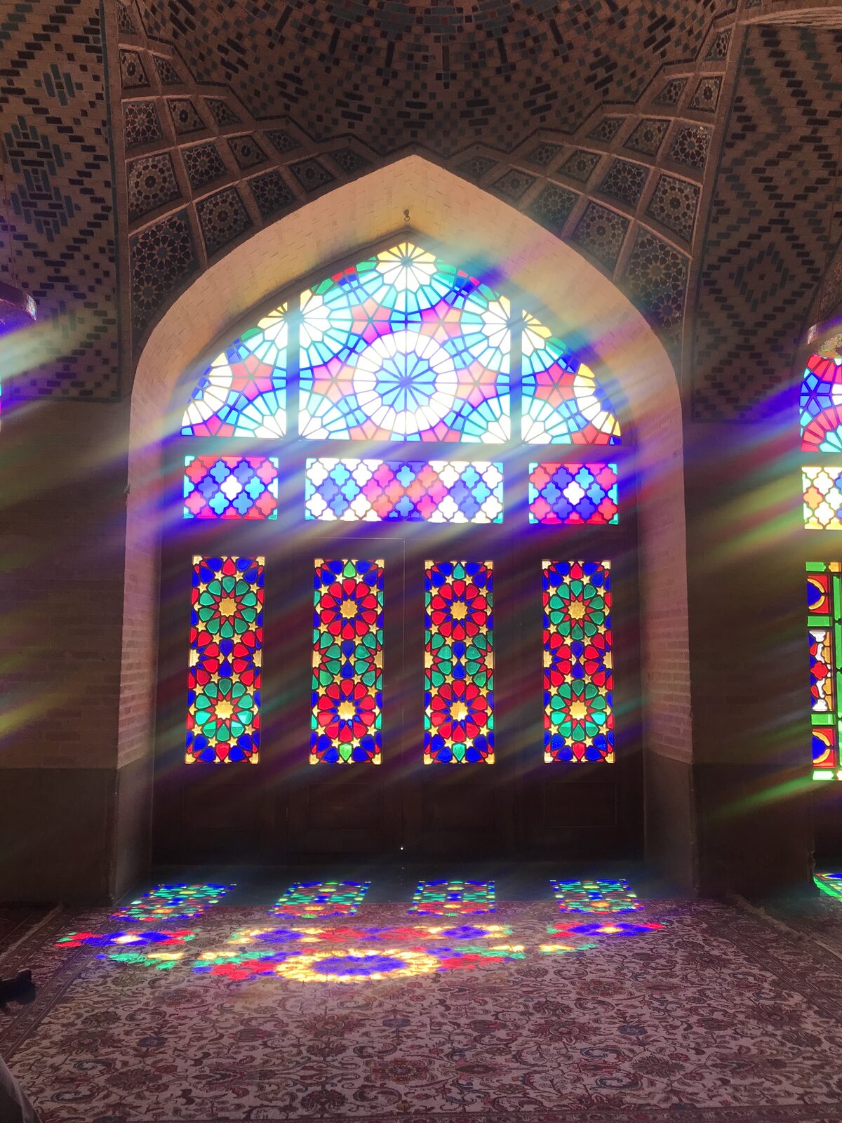 Vitraux colorés de mosquée créant un jeu de lumière